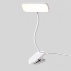 Clipéa | Lampe de bureau LED à pince — produit isolé sur fond gris, arrière-plan retouché.