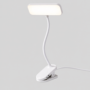 Clipéa | Lampe de bureau LED à pince — produit isolé sur fond gris, arrière-plan retouché.