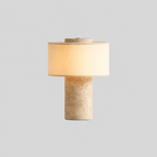 Roche | Lampe nomade en pierre — produit isolé sur fond gris, arrière-plan retouché.