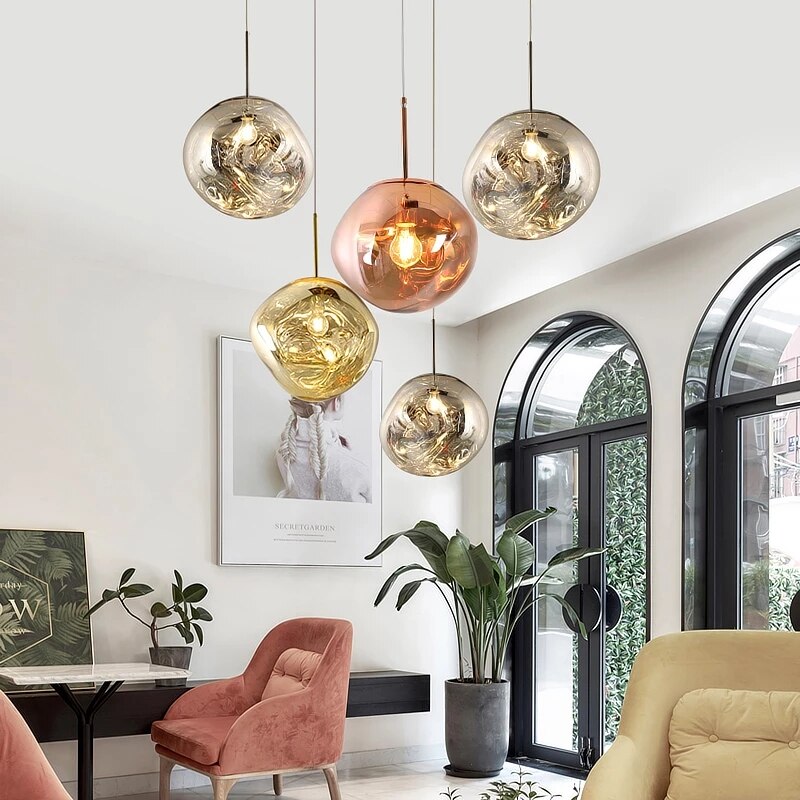 Suspensions Magma en globes irréguliers argentés, doré et cuivré dans un salon