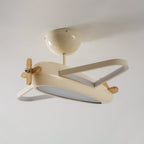 Plafonnier avion beige éteint, montrant les contours des ailes et le diffuseur sous le fuselage.