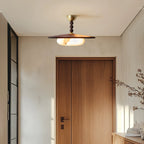 Plafonnier Bosquet allumé au plafond d’une entrée beige avec porte en bois, vue générale de l’installation.